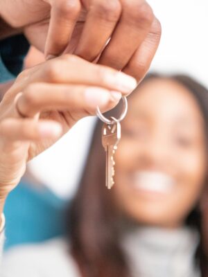 pexels-photo-7579206-7579206 Joyful moment of new homeowners receiving keys to their new house, symbolizing hope and new beginnings.